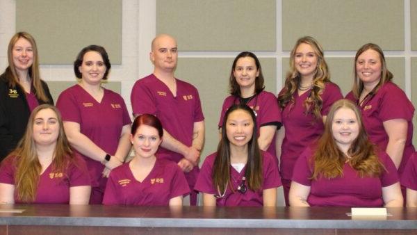 14 vet tech students in scrubs